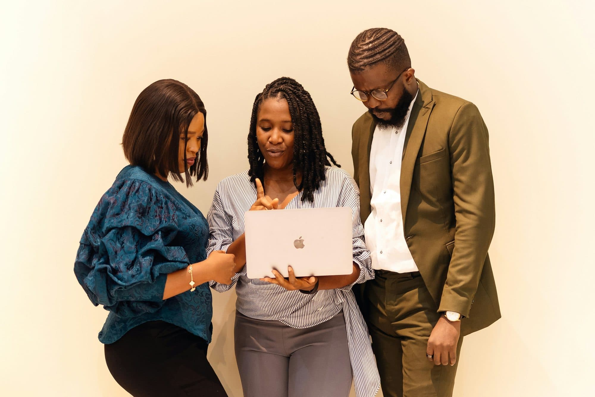 A small team working together around a laptop