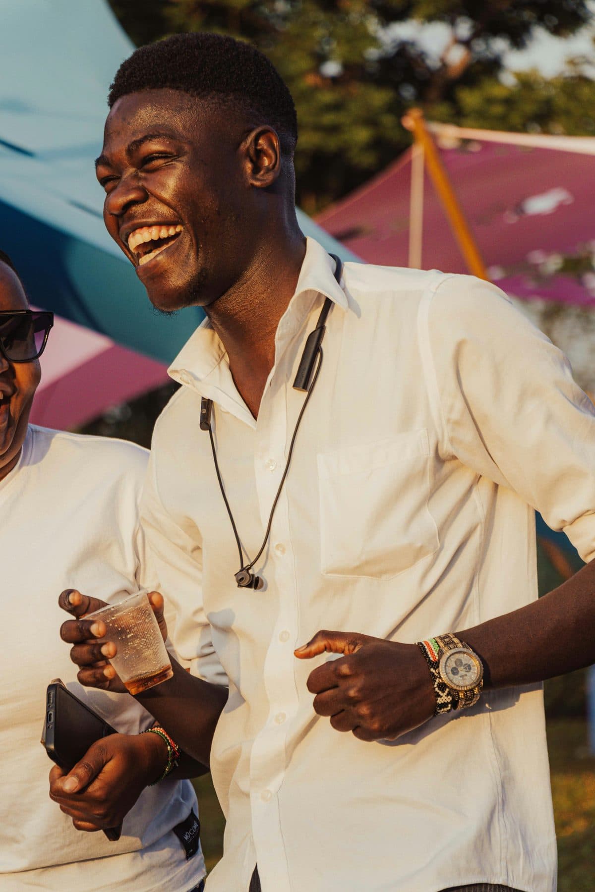 A young man laughing at an event