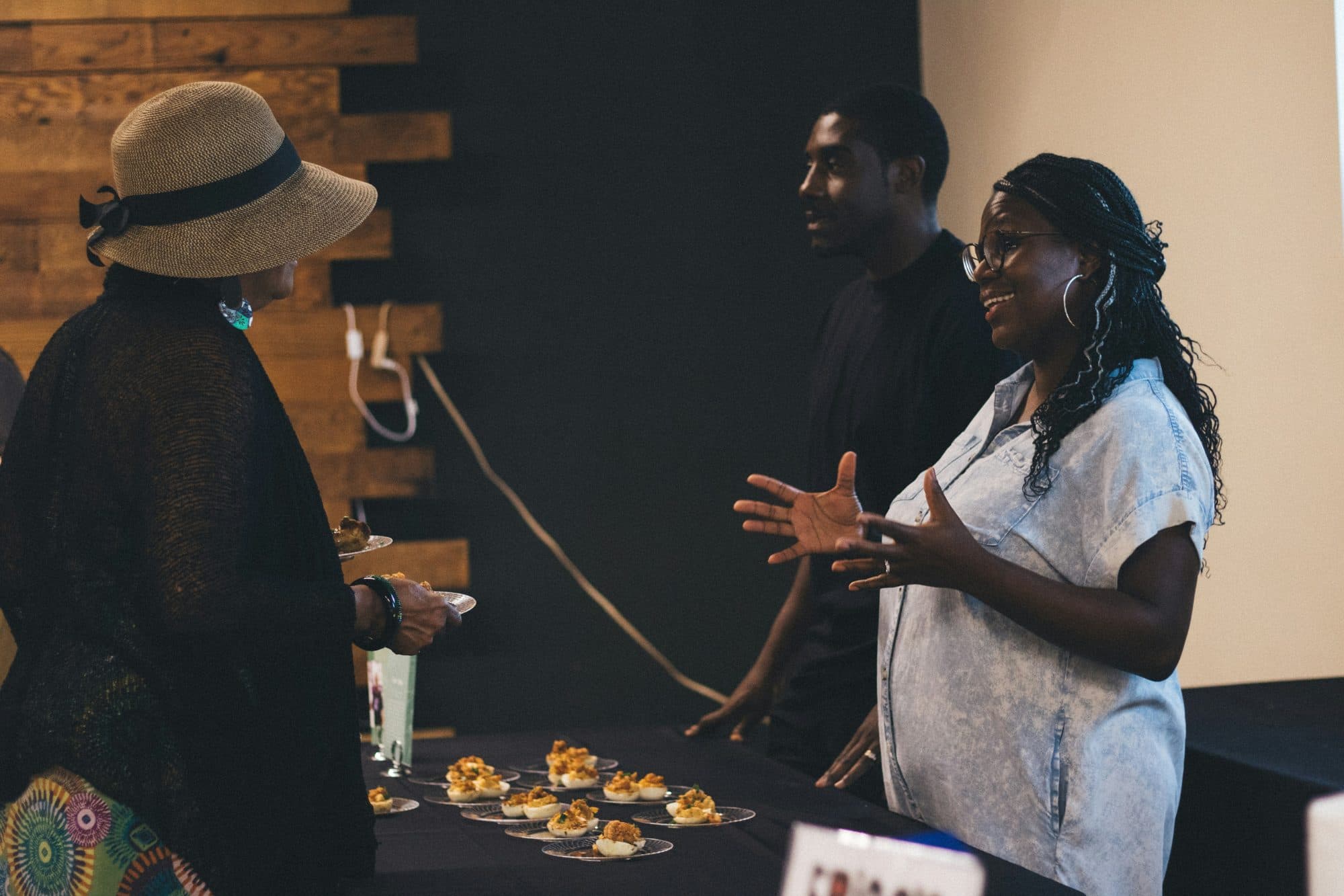 People talking together around a table of food