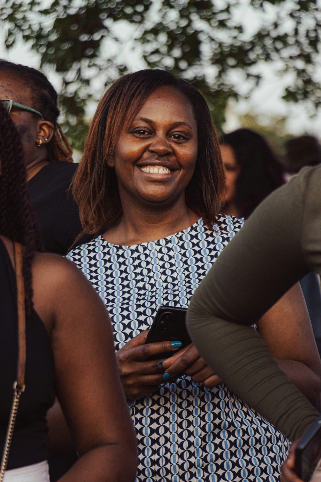 A smiling young woman at a gathering