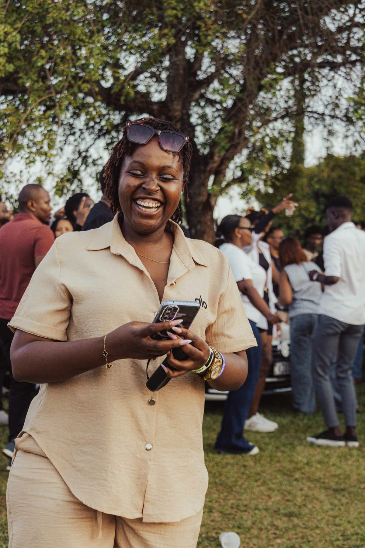 A young woman smiling at her phone