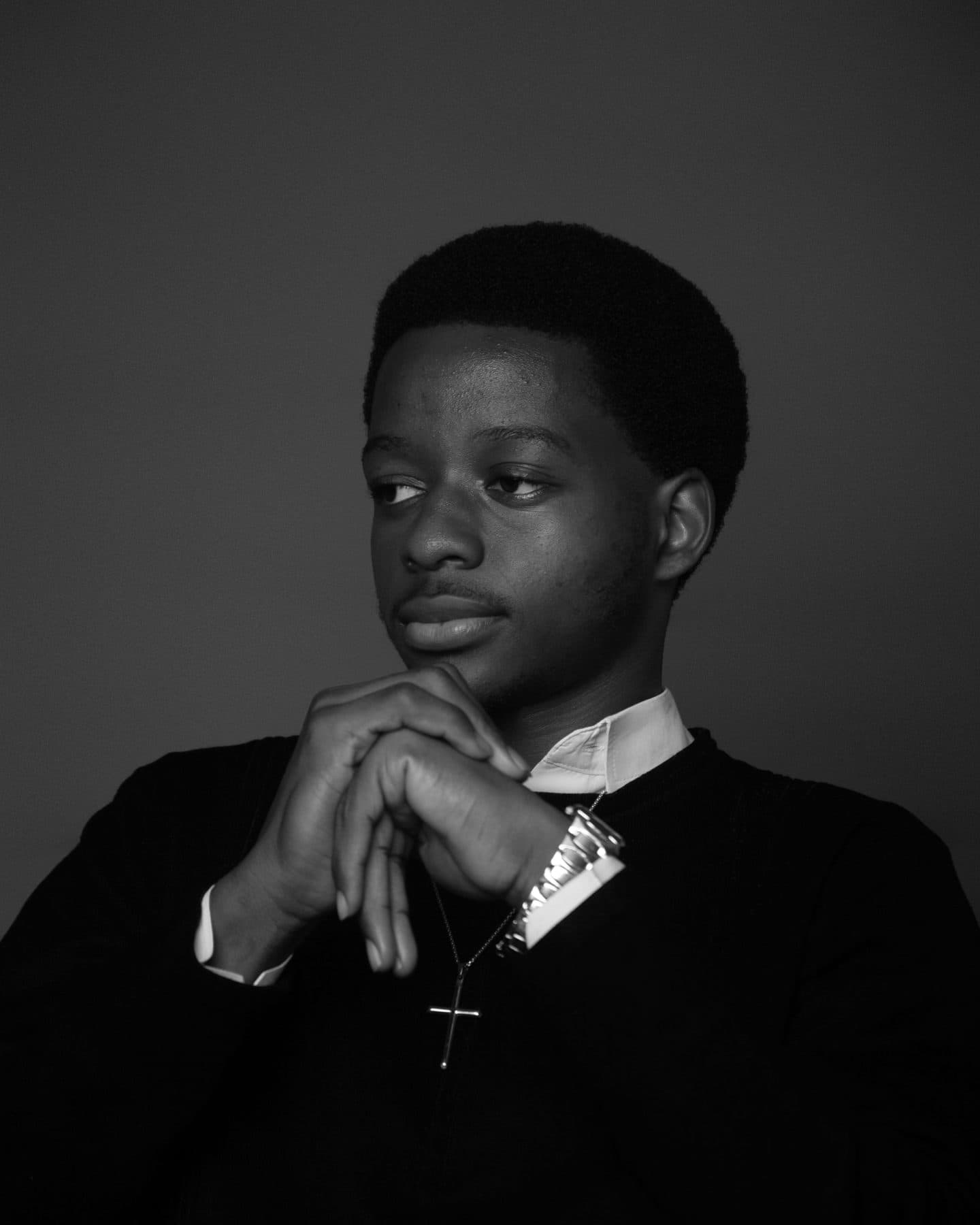 A young man praying with a rosary